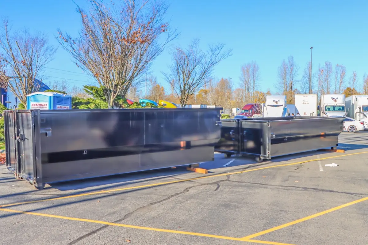 Professional dumpster rental service with roll-off container on residential driveway in Springdale